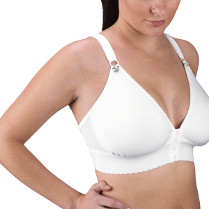 A woman models a white cotton knit compression bra, showcasing the 2″ Band Cotton Knit Bra by Design Veronique.