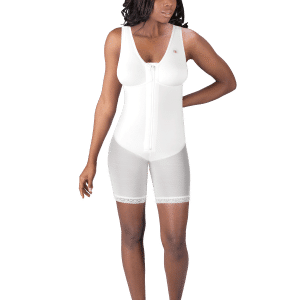 A woman models a white zippered bodysuit, featuring the zippered mid-thigh molded buttocks high-back girdle with bra by Design Veronique.